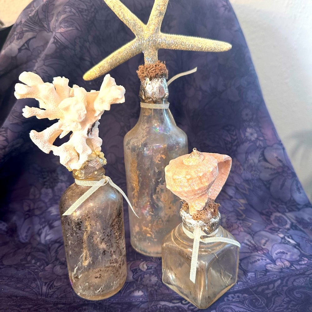 Set of 3 vintage bottled fused with  beautiful seashells.